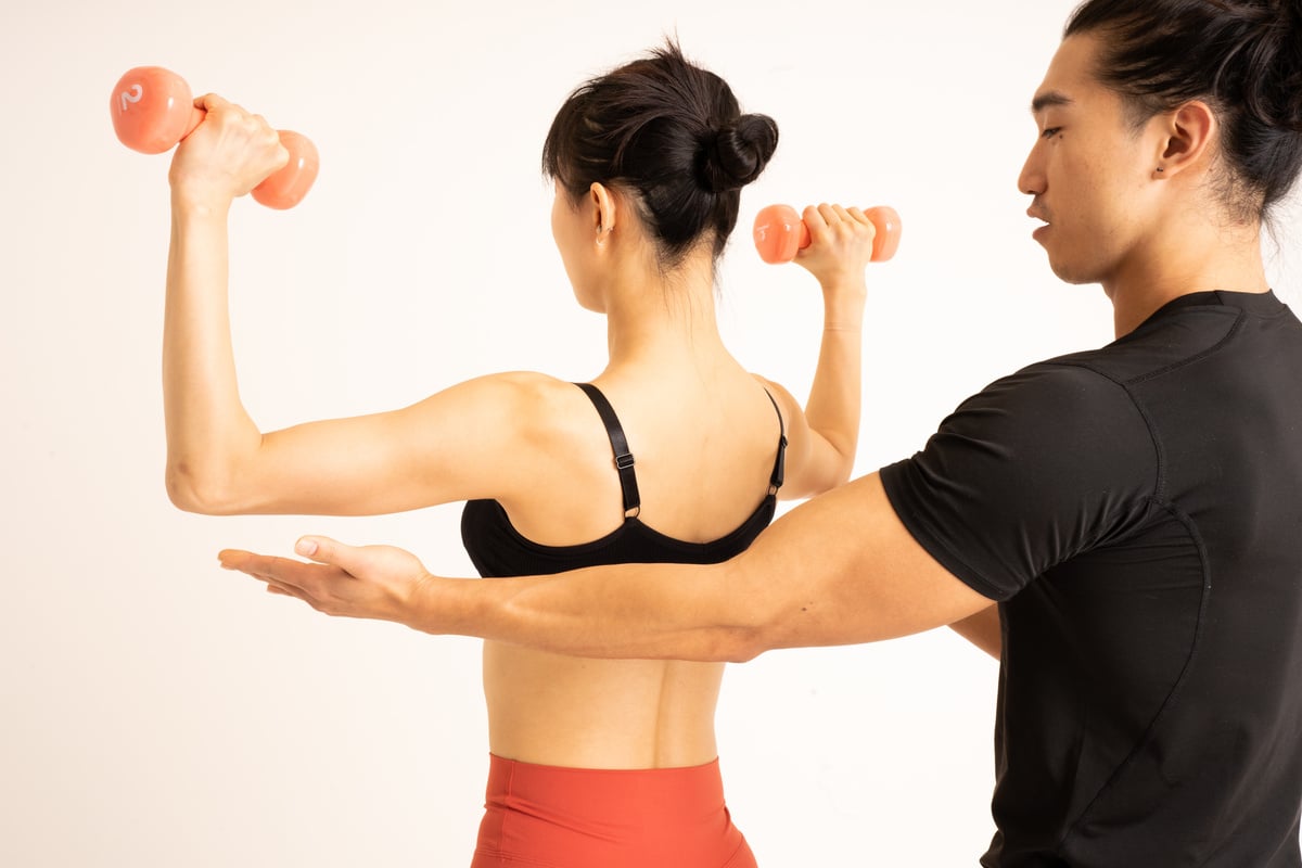 Woman Working Out with a Personal Trainer